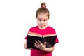 Little girl reads an old book with interest. Isolated on a white background Royalty Free Stock Photo