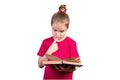 Little girl reads an old book with interest. Isolated on a white background Royalty Free Stock Photo