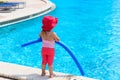 Little girl ready to jump into the pool with noodle Royalty Free Stock Photo