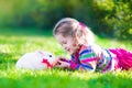 Little girl and real rabbit Royalty Free Stock Photo