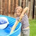 Little girl recharging water gun