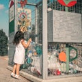 Little Girl Recycling Plastic Water Bottles. Crate of plastic water bottles ready for recycling in bin.