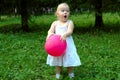 Little girl with red balloon in the forest. Royalty Free Stock Photo