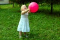 Little girl with red balloon in the forest. Royalty Free Stock Photo