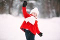 Little girl in red coat with a teddy bear having fun on winter day. girl playing in the snow Royalty Free Stock Photo