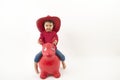 Little girl with red cowboy hat riding o toy horse Royalty Free Stock Photo