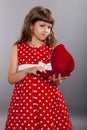 Little girl in red dress holding her present Royalty Free Stock Photo