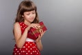 Little girl in red dress holding her present Royalty Free Stock Photo