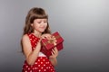 Little girl in red dress holding her present Royalty Free Stock Photo