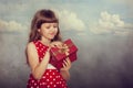 Little girl in red dress holding her present Royalty Free Stock Photo