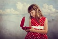 Little girl in red dress holding her present Royalty Free Stock Photo