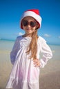 Little girl in red hat santa claus and sunglasses Royalty Free Stock Photo