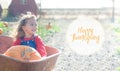 Happy smiling girl sitting inside wheelbarrow at field pumpkin patch Royalty Free Stock Photo