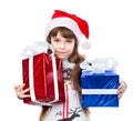 Little girl in red sana hat and gift boxes. isolated on white Royalty Free Stock Photo