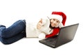 Little girl in red Santa hat with laptop Royalty Free Stock Photo