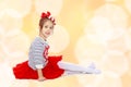 Little girl in a red skirt and bow on her head. Royalty Free Stock Photo