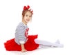 Little girl in a red skirt and bow on her head. Royalty Free Stock Photo