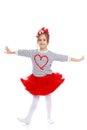 Little girl in a red skirt and bow on her head. Royalty Free Stock Photo