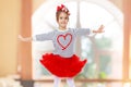 Little girl in a red skirt and bow on her head. Royalty Free Stock Photo