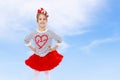 Little girl in a red skirt and bow on her head. Royalty Free Stock Photo