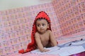 Little Girl in red towel ,cute baby playing n bed