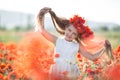 Cute little girl on the meadow of red poppies in spring day Royalty Free Stock Photo