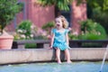 Little girl refreshing in a fountain Royalty Free Stock Photo