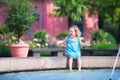 Little girl refreshing in fountain Royalty Free Stock Photo