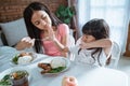 Little girl refuses to eat and her older sister is annoyed Royalty Free Stock Photo