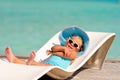 Little girl relaxing in tropic ocean background