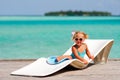 Little girl relaxing in tropic ocean background