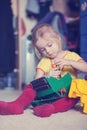 Little girl repairing a toy truck with a screwdriver Royalty Free Stock Photo