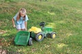 Little girl repairing a tractor