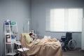 A little girl resting in bed in a hospital ward, she is talking to her family via her digital tablet Royalty Free Stock Photo