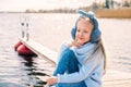 Little girl resting sitting by the river in spring nature Royalty Free Stock Photo