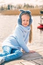 Little girl resting sitting by the river in spring nature Royalty Free Stock Photo