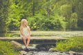 Little girl resting on wooden bridge in summer Royalty Free Stock Photo