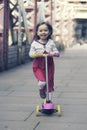 Little girl ridding scooter