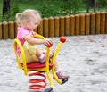 Little girl ridding spring swing