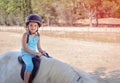 Little girl rider on a white pony. Royalty Free Stock Photo