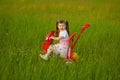 Little girl rides a bicycle on field Royalty Free Stock Photo