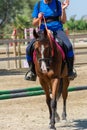 Little girl that rides a brown pony during Pony Game competition at the Equestrian School