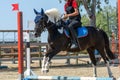 Little girl that rides a brown pony during Pony Game competition at the Equestrian School