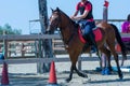 Little girl that rides a brown pony during Pony Game competition at the Equestrian School