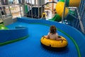Little girl rides in wheel on the slide
