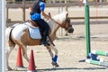 Little girl that rides a white pony during Pony Game competition at the Equestrian School