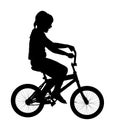 Little girl riding bicycle vector silhouette illustration isolated on white background