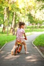 Little girl riding a bike on a sunny day