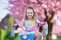 Little girl riding a bike on sunny spring day Royalty Free Stock Photo