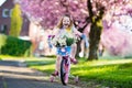 Little girl riding a bike on sunny spring day Royalty Free Stock Photo